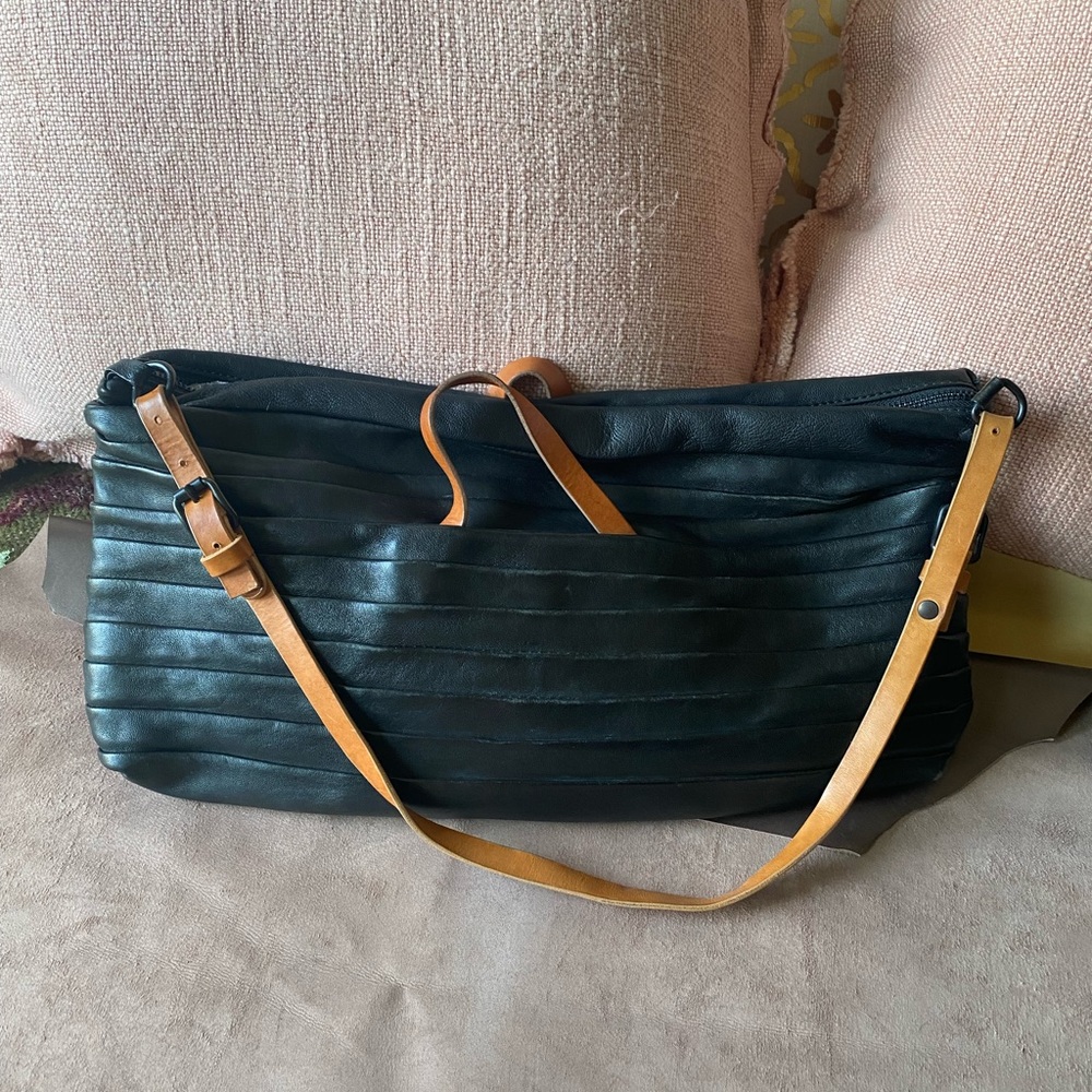 Black leather handbag with contrasting shoulder and handle straps.